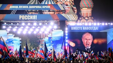 Russian President Vladimir Putin is seen on a screen set at Red Square as he addresses a rally and a concert marking the annexation of four regions of Ukraine Russian troops occupy - Lugansk, Donetsk, Kherson and Zaporizhzhia, in central Moscow on September 30, 2022. (Photo by Alexander NEMENOV / AFP)