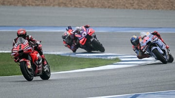 Ducati Lenovo Team's Italian rider Francesco Bagnaia (L) rides in front of Gresini Racing MotoGP's Spanish rider Marc Marquez (R) and Prima Pramac Racing's Spanish rider Jorge Martin (C) during the MotoGP Thailand Grand Prix at the Buriram International Circuit in Buriram on October 27, 2024. (Photo by Lillian SUWANRUMPHA / AFP)