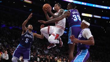 Nov 15, 2021; Los Angeles, California, USA; Chicago Bulls forward DeMar DeRozan (11) is defended by Los Angeles Lakers guard Talen Horton-Tucker (5) and center Dwight Howard (39) in the second half at Staples Center. The Bulls defeated the Lakers 121-103. Mandatory Credit: Kirby Lee-USA TODAY Sports