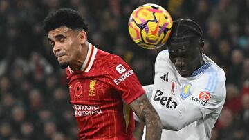 Aston Villa's Belgian defender #24 Amadou Onana heads the ball clear under pressure from Liverpool's Colombian midfielder #07 Luis Diaz during the English Premier League football match between Liverpool and Aston Villa at Anfield in Liverpool, north west England on November 9, 2024. (Photo by Paul ELLIS / AFP) / RESTRICTED TO EDITORIAL USE. No use with unauthorized audio, video, data, fixture lists, club/league logos or 'live' services. Online in-match use limited to 120 images. An additional 40 images may be used in extra time. No video emulation. Social media in-match use limited to 120 images. An additional 40 images may be used in extra time. No use in betting publications, games or single club/league/player publications. /