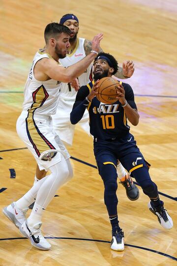 NEW ORLEANS, LOUISIANA - MARCH 01: Mike Conley #10 of the Utah Jazz drives against Willy Hernangomez #9 of the New Orleans Pelicans during the second half at the Smoothie King Center on March 01, 2021 in New Orleans, Louisiana.