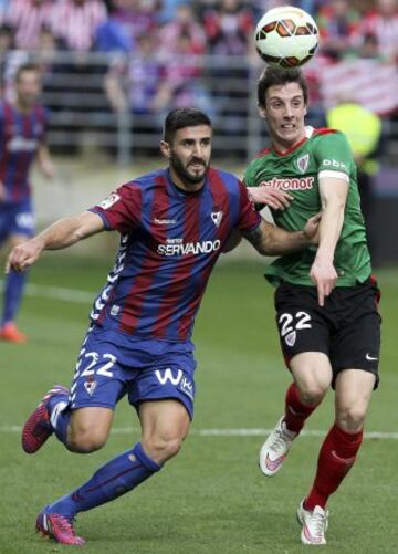 El defensa del Eibar Raúl Navas  lucha un balón con el delantero del Athletic de Bilbao Guillermo Fernández durante el partido de la vigésima quinta jornada de Liga de Primera División.