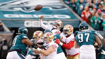 San Francisco 49ers quarterback Josh Johnson #17 (C) is tackled by the Philadelphia Eagles defense as he tries to throw