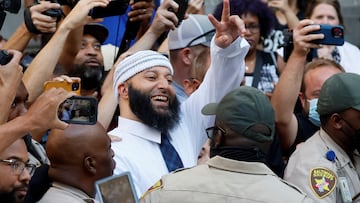 Adnan Syed, whose case was chronicled in the hit podcast "Serial," smiles and waves as he leaves the courthouse after a judge overturned Syed's murder conviction and ordered a new trial during a hearing.