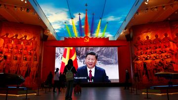 Visitors stand in front of a giant screen displaying Chinese President Xi Jinping next to a flag of the Communist Party of China, at the Military Museum of the Chinese People's Revolution in Beijing, China October 8, 2022. REUTERS/Florence Lo