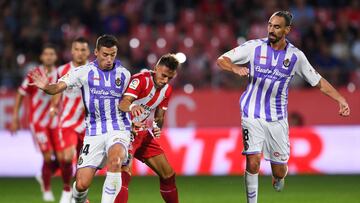 GIRONA, SPAIN - AUGUST 17: Aleix Garcia of Girona FC competes for the ball with Ruben Alcaraz (L) and Borja Fernandez of Real Valladolid CF during the La Liga match between Girona FC and Real Valladolid CF at Montilivi Stadium on August 17, 2018 in Giron