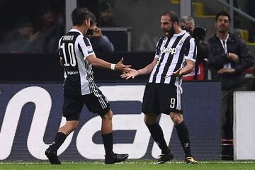 Juventus' forward Gonzalo Higuain from Argentina (R) celebrates with teammate Juventus's forward from Argentina Paulo Dybala after scoring during the Italian Serie A football match AC Milan Vs Juventus on October 28, 2017 at the 'Giuseppe Meazza' Stadium 