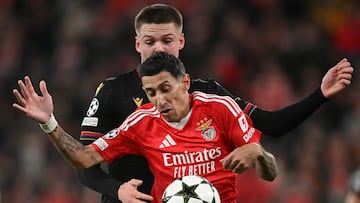 Benfica's Argentine midfielder #11 Angel Di Maria fights for the ball with Bologna's Swedish midfielder #02 Emil Holm during the UEFA Champions League, league phase football match between SL Benfica and Bologna FC 1909 at Estadio da Luz in Lisbon on December 11, 2024. (Photo by PATRICIA DE MELO MOREIRA / AFP)