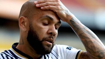 (FILES) Pumas' Brazilian defender Dani Alves gestures during the Mexican Apertura tournament football match against Atlas at the Jalisco stadium in Guadalajara, Jalisco State, Mexico, on September 3, 2022. Dani Alves appeared today before a Barcelona judge who notified him that he will go on trial for rape, a decision that the Brazilian footballer did not oppose in order not to delay the process, the Spanish justice system and his defence reported. Alves, who has been in jail since January, showed "his opposition" to the trial, for which there is no date. (Photo by Ulises Ruiz / AFP)