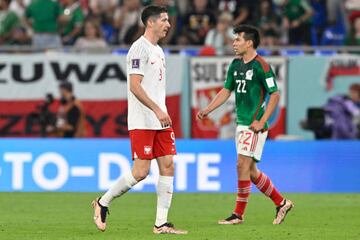 Poland's forward #09 Robert Lewandowski (L) walks on the pitch past Mexico's forward #22 Hirving Lozano during the Qatar 2022 World Cup Group C football match between Mexico and Poland at Stadium 974 in Doha on November 22, 2022. (Photo by Alfredo ESTRELLA / AFP) (Photo by ALFREDO ESTRELLA/AFP via Getty Images)