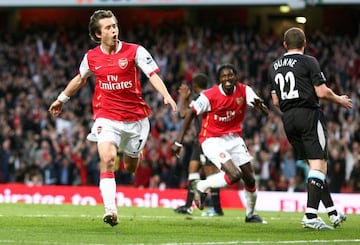 Arsenal's Czech midfielder Tomas Rosicky celebrates scoring his side's opening goal against Man City in 2007, with team mate Emmanuel Adebayor chasing behind.