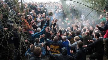 Competitors from the opposing teams, the Up&#039;ards and the Down&#039;ards, reach for the ball during the annual Royal Shrovetide Football Match in Ashbourne, northern England, on February 28, 2017. 
 The mass-participation ball game involves two teams, whose players are defined by which side of a small brook that bisects the town they were born, aiming to score a goal, which are some three miles apart. The game, which has very few rules, is played over two 8 hour periods on Shrove Tuesday and Ash Wednesday. Royal Shrovetide Football is believed to have been played annually in Ashbourne since 1667.  / AFP PHOTO / OLI SCARFF