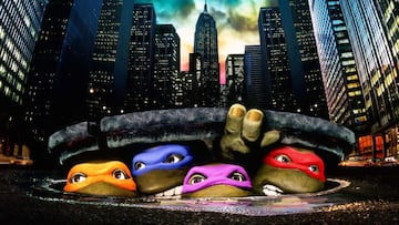 The four Teenage Mutant Ninja Turtles pose in a sewer tunnel, ready for action, in a still from the 1990 live-action film