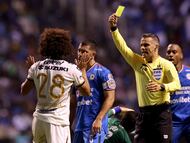Soccer Football - Liga MX - Cruz Azul v Pumas UNAM - Estadio Cuauhtemoc, Puebla, Mexico - November 8, 2025 Pumas UNAM's Adalberto Carrasquilla is shown a yellow card by referee Fernando Hernandez Gomez REUTERS/Henry Romero