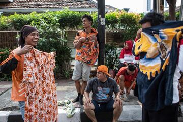 Los vecinos se visten para jugar un partido de fútbol en la calle Jaksa que se encuentra en el centro de Jakarta.
