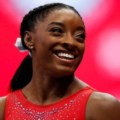 FILE PHOTO: Simone Biles smiles at a teammate during the final day of women's competition in the U.S. Olympic Team Trials for gymnastics in St. Louis, Missouri, U.S., June 27, 2021. REUTERS/Lindsey Wasson/File Photo