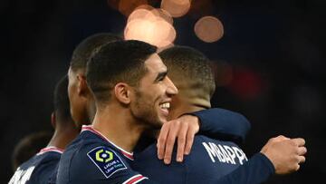 Paris Saint-Germain's French forward Kylian Mbappe (R) celebrates with Paris Saint-Germain's Moroccan defender Achraf Hakimi (L) after scoring the 3-1 goal during the French L1 football match between Paris Saint-Germain (PSG) and FC Lorient at the Parc des Princes stadium in Paris on April 3, 2022. (Photo by FRANCK FIFE / AFP) (Photo by FRANCK FIFE/AFP via Getty Images)