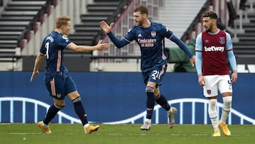 LONDON, ENGLAND - MARCH 21: Calum Chambers of Arsenal celebrates his side's second goal with Martin Odegaard during the Premier League match between West Ham United and Arsenal at London Stadium on March 21, 2021 in London, England. Sporting stadiums