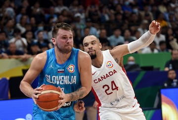 Basketball - FIBA World Cup 2023 - Quarter-Final - Canada v Slovenia - Mall of Asia Arena, Manila, Philippines - September 6, 2023 Slovenia's Luka Doncic in action with Canada's Dillon Brooks REUTERS/Lisa Marie David