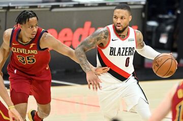 May 5, 2021; Cleveland, Ohio, USA; Cleveland Cavaliers forward Isaac Okoro (35) defends Portland Trail Blazers guard Damian Lillard (0) during the third quarter at Rocket Mortgage FieldHouse. Mandatory Credit: Ken Blaze-USA TODAY Sports