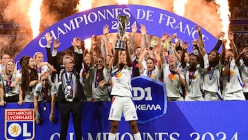 Olympique Lyonnais players celebrate after being crowned French Women's D1 Champions at the end of the D1 Women's football match between Lyon (OL) and Paris (PSG) at the Groupama Stadium in Decines-Charpieu, central-eastern France, on May 17, 2024. (Photo by OLIVIER CHASSIGNOLE / AFP)