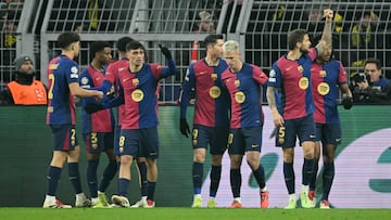 Barcelona's players celebrate the opening goal scored by Barcelona's Brazilian forward #11 Raphinha during the UEFA Champions League football match between Borussia Dortmund and FC Barcelona in Dortmund, western Germany on December 11, 2024. (Photo by INA FASSBENDER / AFP)