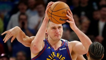 Mar 19, 2024; Minneapolis, Minnesota, USA; Denver Nuggets center Nikola Jokic (15) works to keep the ball away from the Minnesota Timberwolves in the third quarter at Target Center. Mandatory Credit: Bruce Kluckhohn-USA TODAY Sports