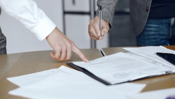 Business men sitting at the lawyers's desk. People signing important documents.