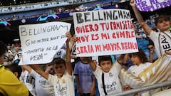 Young supporters hold sign reading '(Real Madrid's English midfielder #5 Jude) Bellingham give me your shirt please, today is my birthday' prior the UEFA Champions League 1st round day 1 group C football match between Real Madrid and Union Berlin at the Santiago Bernabeu stadium in Madrid on September 20, 2023. (Photo by Thomas COEX / AFP)