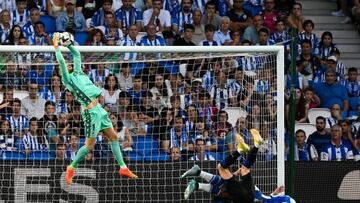 Real Sociedad's Spanish goalkeeper Alex Remiro (L) jumps for the ball during the Spanish league football match between Real Sociedad and Club Atletico de Madrid, at the Anoeta stadium in San Sebastian, on September 3, 2022. (Photo by PIERRE-PHILIPPE MARCOU / AFP) (Photo by PIERRE-PHILIPPE MARCOU/AFP via Getty Images)