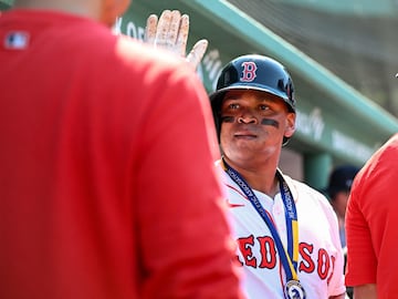 Rafael Devers #11 of the Boston Red Sox celebrates with his teammates 