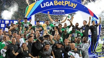 Nacional players celebrate with the trophy after winning the Colombian League second leg football final match between Atletico Nacional and Deportes Tolima at the Atanasio Girardot Stadium in Medellin, Colombia on December 22, 2024. (Photo by JAIME SALDARRIAGA / AFP)