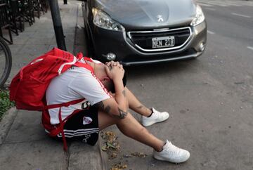 A fan of Argentina's River Plate team reacts after their team lost 2-1 the Copa Libertadores football final against Brazil's Flamengo at a bar in Buenos Aires, on November 23, 2019