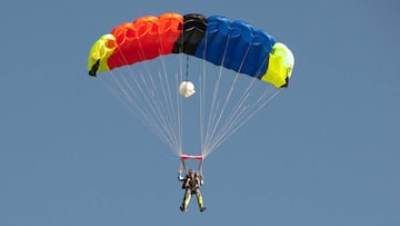 Salto t&aacute;ndem en paraca&iacute;das con un paraca&iacute;das de colores amarillo, rojo, negro y azul. 