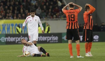 Krohn-Dehli writhes in pain as Shakhtar's shocked players immediately betray the extent of the injury.