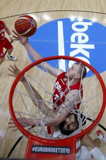 El ala-p¨ªvot polaco Damian Kulig (arriba) lanza a canasta ante el espa?ol Nikola Mirotic (abajo), durante el partido de octavos de final del Europeo 2015 entre las selecciones de Espa?a y Polonia, celebrado en el estadio Pierre Mauroy de la localidad francesa de Lille.