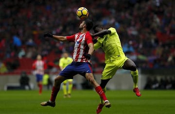 Diego Costa wins the header after Djene Dakonam Ortega of Getafe CF during the La Liga match between Club Atletico Madrid and Getafe CF