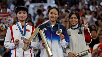 South Korea's gold medallist An Se-young, China's silver medallist He Bing Jiao, and Indonesia's bronze medallist Gregoria Mariska Tunjung pose with their medals on the podium at the women's singles badminton medal ceremony during the Paris 2024 Olympic Games at Porte de la Chapelle Arena in Paris on August 5, 2024. (Photo by Luis TATO / AFP)