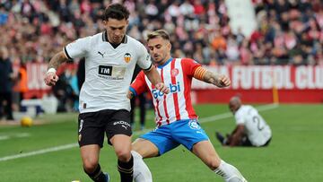 Girona's Spanish midfielder #14 Aleix Garcia (R) vies with Valencia's Spanish forward #9 Hugo Duro during the Spanish league football match between Girona FC and Valencia CF at the Montilivi stadium in Girona on December 1, 2023. (Photo by LLUIS GENE / AFP)