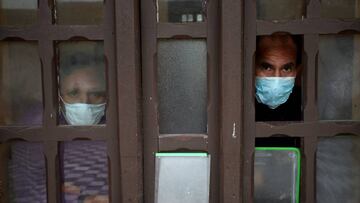 LIMA, PERU - JUNE 25: Two coronavirus infected patients look out from the window while in isolation at Victor Larco Herrera Mental Hospital on June 25, 2020 in Lima, Peru. Tests carried at the largest mental hospital in Peru confirmed that 162 of of 342 patients and 121 workers were infected with COVID-19. Authorities informed 95 patients have already recovered. Peru is the second worst-hit country in Latin America with 264.689 positive cases, only after Brazil. (Photo by Raul Sifuentes/Getty Images)