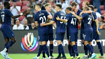 Tottenham Hotspur&#039;s Harry Kane (R partially obscured) is congratulated by teammates after scoring during the International Champions Cup football match between Juventus and Tottenham Hotspur in Singapore on July 21, 2019. (Photo by Roslan RAHMAN / AF