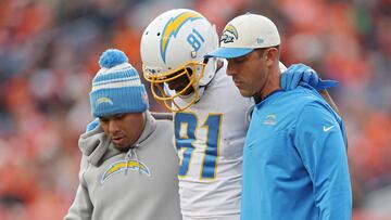 DENVER, COLORADO - JANUARY 08: Trainers assist Mike Williams #81 of the Los Angeles Chargers off the field during the first half against the Denver Broncos at Empower Field At Mile High on January 08, 2023 in Denver, Colorado.   Matthew Stockman/Getty Images/AFP (Photo by MATTHEW STOCKMAN / GETTY IMAGES NORTH AMERICA / Getty Images via AFP)