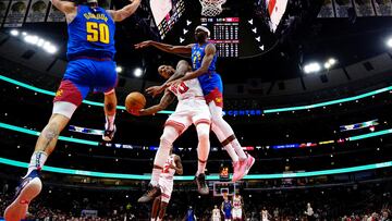 Denver Nuggets forward Justin Holiday (9) and forward Aaron Gordon (50) defends Chicago Bulls forward DeMar DeRozan (11)