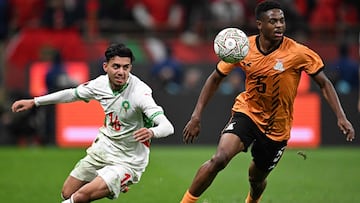 Morocco's forward #16 Ilias Akhomach (L) fights for the ball with Zambia's midfielder #05 Miguel Chaiwa (R) during the Africa Cup of Nations (CAN) group stage football match between Zambia and Morocco at Prince Moulay Abdellah Stadium in Rabat on December 29, 2025. (Photo by Gabriel BOUYS / AFP)