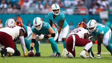 MIAMI GARDENS, FLORIDA - AUGUST 17: Tua Tagovailoa #1 of the Miami Dolphins looks on at the line of scrimmage against the Washington Commanders during the first quarter of a preseason game at Hard Rock Stadium on August 17, 2024 in Miami Gardens, Florida. (Photo by Megan Briggs/Getty Images)