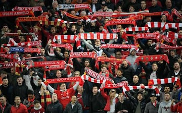 Liverpool's supporters celebrate at the end of the UEFA Champions League quarter-final, first leg football match between Liverpool and FC Porto at Anfield stadium in Liverpool, north-west England