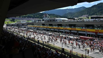 Fans run across the Red Bull Ring race track after the Formula One Austrian Grand Prix in Spielberg, Austria, on June 29, 2025. (Photo by Joe Klamar / AFP)