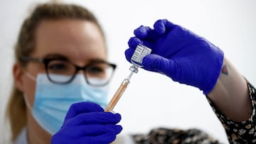 FILE PHOTO: A health worker fills a syringe with a dose of the Oxford/AstraZeneca COVID-19 vaccine at the Appleton Village Pharmacy, amid the coronavirus disease (COVID-19) outbreak, in Widnes, Britain January 14, 2021. REUTERS/Jason Cairnduff/File Photo