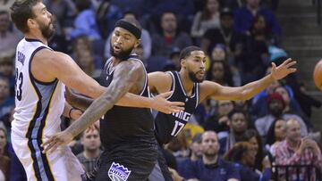 Memphis Grizzlies center Marc Gasol, left, passes the ball around Sacramento Kings forward DeMarcus Cousins, center, and guard Garrett Temple (17) in the first half of an NBA basketball game Friday, Dec. 16, 2016, in Memphis, Tenn. (AP Photo/Brandon Dill)