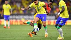 Brazil's defender Bruno Guimaraes (Front) fights for the ball with Guinea's midfielder Seydouba Cisse during the international friendly football match between Brazil and Guinea at the RCDE Stadium in Cornella de Llobregat near Barcelona on June 17, 2023. (Photo by Pau BARRENA / AFP)